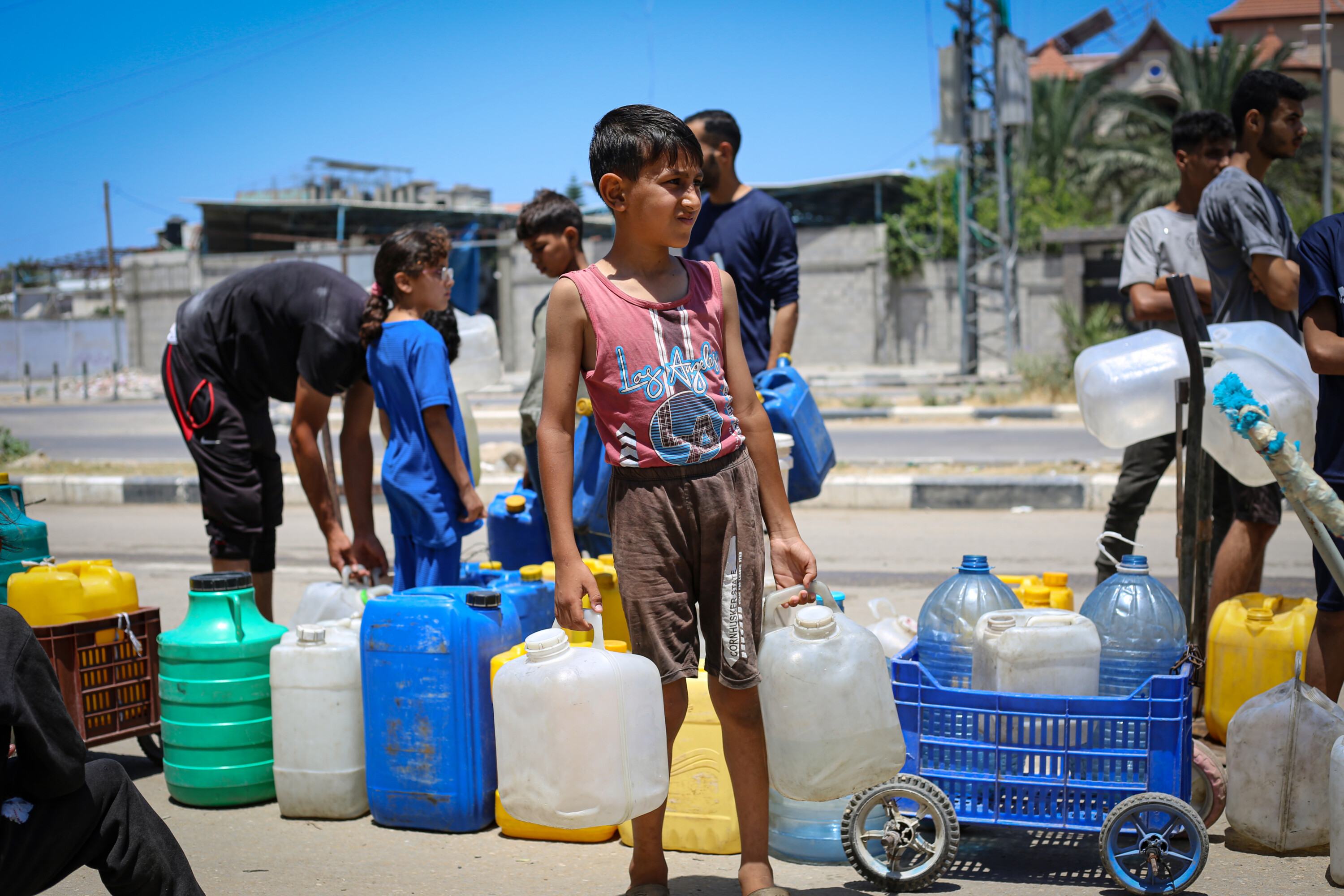 Children accessing drinking water from a communal tap